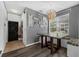 Dining area with dark wood-look flooring and modern orb light fixture at 2330 Little Gem Loop, Sanford, FL 32773