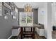Bright dining area with dark wood-look flooring and views of the yard at 2330 Little Gem Loop, Sanford, FL 32773