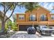 Two-story townhome with attached garage and balcony, featuring a tan stucco exterior at 2330 Little Gem Loop, Sanford, FL 32773