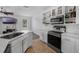Bright kitchen with stainless steel appliances, white cabinets, and tiled backsplash at 2330 Little Gem Loop, Sanford, FL 32773