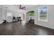 Open living room with laminate floors, ceiling fan, and media setup at 2330 Little Gem Loop, Sanford, FL 32773