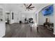 Bright, open-concept living room featuring modern flooring and a stylish ceiling fan at 2330 Little Gem Loop, Sanford, FL 32773