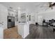 Open-concept living space with modern kitchen, wood floors, and natural light at 2330 Little Gem Loop, Sanford, FL 32773