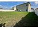 Spacious backyard is fully fenced, with the exterior of the home in view at 235 Hibiscus St, Winter Haven, FL 33881