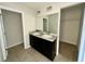 Bathroom with double sink vanity and bright vanity lights at 235 Hibiscus St, Winter Haven, FL 33881