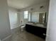 Bathroom featuring tiled floors, dual sinks and a tub at 235 Hibiscus St, Winter Haven, FL 33881