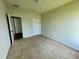 Simple bedroom with carpet, closet, and neutral walls ready for your personal touch at 235 Hibiscus St, Winter Haven, FL 33881