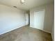 Bedroom showcases neutral paint, carpet, and a double-door closet with an additional entry doorway at 235 Hibiscus St, Winter Haven, FL 33881