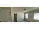 A carpeted bedroom with neutral walls and two windows at 235 Hibiscus St, Winter Haven, FL 33881