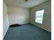 Bedroom featuring a window offering natural light with blue painted flooring at 235 Hibiscus St, Winter Haven, FL 33881