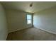 Carpeted bedroom featuring neutral paint and a window at 235 Hibiscus St, Winter Haven, FL 33881