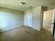 A bedroom with neutral carpet and a closet at 235 Hibiscus St, Winter Haven, FL 33881