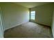Cozy bedroom with neutral carpet, a single window, and ready for personalization at 235 Hibiscus St, Winter Haven, FL 33881