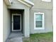 The front entrance leads to a well-lit space featuring a modern black front door at 235 Hibiscus St, Winter Haven, FL 33881