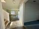 Foyer and staircase leading to the living room, blending tile and wood flooring at 235 Hibiscus St, Winter Haven, FL 33881