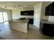 A spacious kitchen featuring an island with sink and black cabinetry at 235 Hibiscus St, Winter Haven, FL 33881