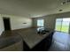Bright living room view showcasing the double sink island and sliding glass doors to backyard at 235 Hibiscus St, Winter Haven, FL 33881