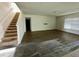 The carpeted staircase ascends into an expansive living area, featuring wood flooring at 235 Hibiscus St, Winter Haven, FL 33881