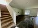 The carpeted staircase ascends into an expansive living area, featuring wood flooring at 235 Hibiscus St, Winter Haven, FL 33881
