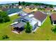 Aerial view of a spacious backyard with a screened-in pool and covered patio area for outdoor relaxation at 2376 Flamingo Lakes Dr, Kissimmee, FL 34743