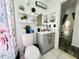 Compact bathroom with decorative shelves, updated vanity and a garden theme at 2376 Flamingo Lakes Dr, Kissimmee, FL 34743