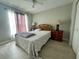 Bedroom with tile floors, ceiling fan, and matching bedside tables with lamps at 2376 Flamingo Lakes Dr, Kissimmee, FL 34743