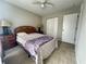 Cozy bedroom with light gray walls, tiled floors, and a ceiling fan at 2376 Flamingo Lakes Dr, Kissimmee, FL 34743