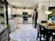 Well-lit kitchen with stainless steel appliances, white cabinetry, and an adjacent dining area at 2376 Flamingo Lakes Dr, Kissimmee, FL 34743