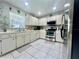 Well-lit kitchen featuring white cabinetry, stainless steel appliances, and tile backsplash, blending style and functionality at 2376 Flamingo Lakes Dr, Kissimmee, FL 34743