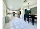 Bright eat-in kitchen featuring white cabinets, stainless steel appliances, and a modern light fixture above the breakfast table at 2376 Flamingo Lakes Dr, Kissimmee, FL 34743