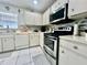 Close-up of kitchen with stainless appliances, tiled backsplash, white cabinetry and ample counter space at 2376 Flamingo Lakes Dr, Kissimmee, FL 34743