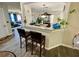 Open concept kitchen and living area with granite counters, breakfast bar, and updated flooring at 2376 Flamingo Lakes Dr, Kissimmee, FL 34743