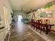 Spacious living and dining area with wood-look tile flooring, stylish furnishings and ample natural light at 2376 Flamingo Lakes Dr, Kissimmee, FL 34743