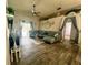 Spacious living area featuring tile floors, a comfortable sofa, and a sliding glass door to the backyard at 2376 Flamingo Lakes Dr, Kissimmee, FL 34743