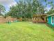 Expansive backyard features a covered deck, tall trees and a wood privacy fence at 2545 El Portal Ave, Sanford, FL 32773