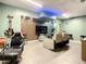 Entertainment basement with large-screen TV, gaming chairs, and custom lighting at 2545 El Portal Ave, Sanford, FL 32773