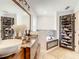 Bathroom boasts dual sinks, a unique shoe rack, and a luxurious soaking tub at 2545 El Portal Ave, Sanford, FL 32773