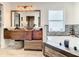 Inviting bathroom with a soaking tub, a large mirror, and dual vessel sinks at 2545 El Portal Ave, Sanford, FL 32773