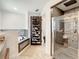 Luxurious bathroom featuring a soaking tub, convenient shoe rack, and a glass-enclosed shower at 2545 El Portal Ave, Sanford, FL 32773