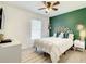 Cute bedroom with leafy headboard, green accent wall, and plenty of sunlight at 2545 El Portal Ave, Sanford, FL 32773