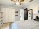 Bedroom with ample closet space, wood-look floors, and modern gray color scheme at 2545 El Portal Ave, Sanford, FL 32773