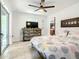 Bedroom featuring a sliding glass door to the patio, rustic wood dresser, and patterned bedding at 2545 El Portal Ave, Sanford, FL 32773