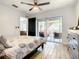 Bedroom showcasing a dresser, bed with patterned linens, and sliding door leading to a screened patio at 2545 El Portal Ave, Sanford, FL 32773