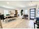 Bright dining room featuring a wood look tile floors, a modern light wood table, and natural light at 2545 El Portal Ave, Sanford, FL 32773