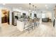 Open kitchen with a granite island, stainless steel appliances, white cabinets, and seamless flow to the living space at 2545 El Portal Ave, Sanford, FL 32773