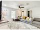 Bright living room features an oversized couch, ceiling fan, and lots of natural light at 2545 El Portal Ave, Sanford, FL 32773