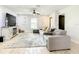 Cozy living room with a comfortable gray sectional sofa, fireplace, stylish décor, and ample space for relaxation at 2545 El Portal Ave, Sanford, FL 32773