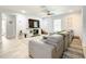 Spacious living room features tile floors and a large gray sectional couch with rug at 2545 El Portal Ave, Sanford, FL 32773