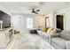 Bright living room features an oversized couch, ceiling fan, and lots of natural light at 2545 El Portal Ave, Sanford, FL 32773