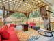 Relaxing covered patio with comfortable seating, a fire pit, and a hammock swing at 2545 El Portal Ave, Sanford, FL 32773